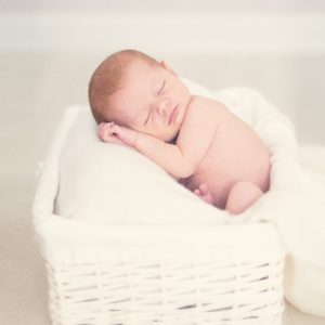 cute baby asleep in basket