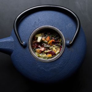 top down picture of blue iron chinese herb kettle containing herbs