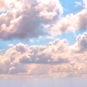 pretty blue skyy with pink tinged cumulus clouds