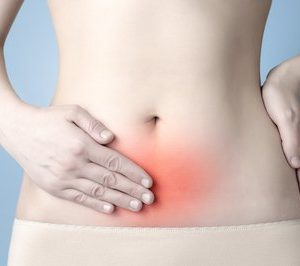 Womens abdomen with hand on inflamed patch