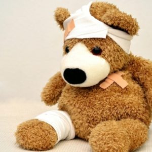 toy teddy bear with bandages and elastoplast