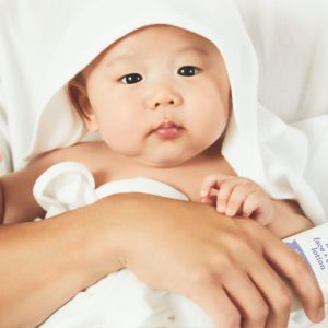 Cute Chinese baby in white toweling robe